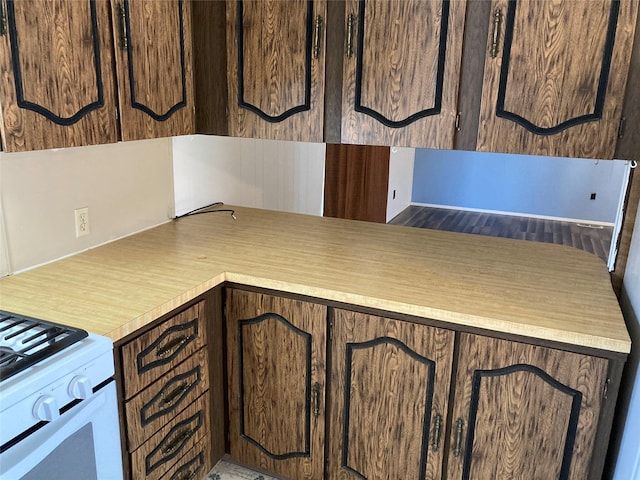 412 N Surrey St, Missoula, MT 59808 - kitchen featuring light countertops, dark brown cabinetry, and white range with gas stovetop
