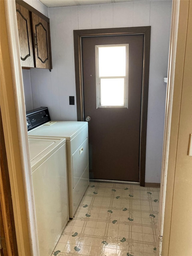 412 N Surrey St, Missoula, MT 59808 - washroom with washer and clothes dryer, cabinet space, and light flooring