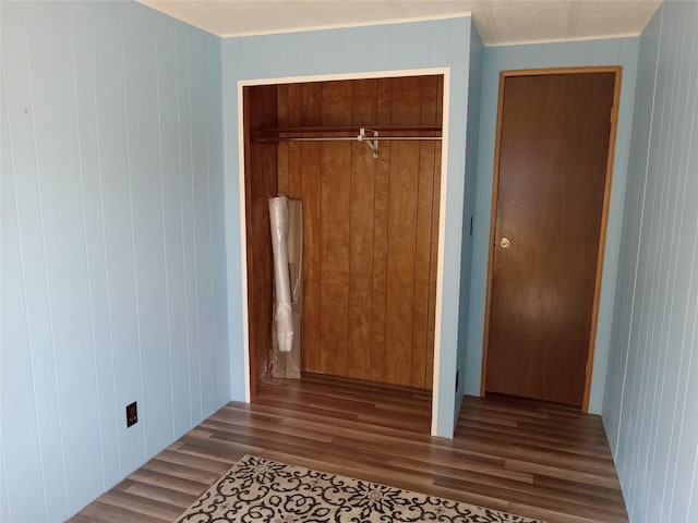 412 N Surrey St, Missoula, MT 59808 - unfurnished bedroom featuring wood finished floors, a closet, and wood walls