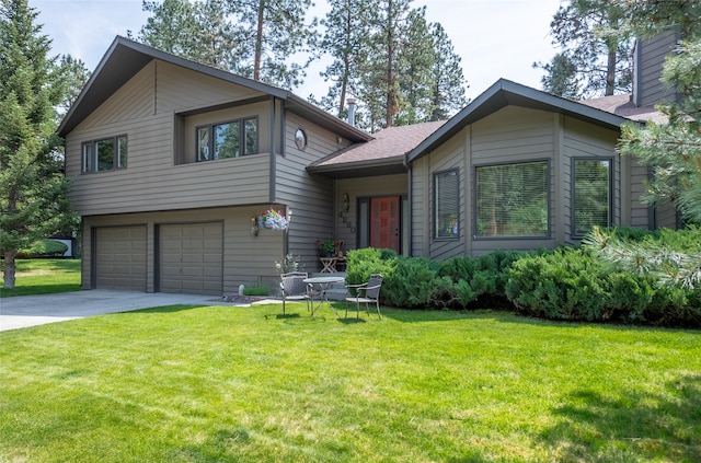 4280 Fox Farm Rd, Missoula, MT 59802 - split level home featuring concrete driveway, a garage, a front yard, and a chimney