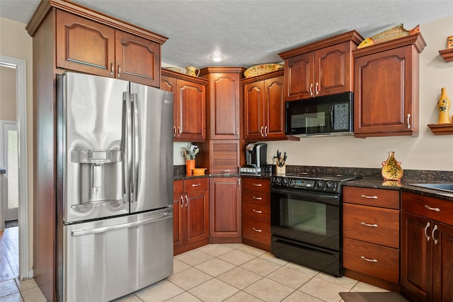 4280 Fox Farm Rd, Missoula, MT 59802 - kitchen featuring black appliances, light tile patterned floors, dark stone countertops, and a textured ceiling
