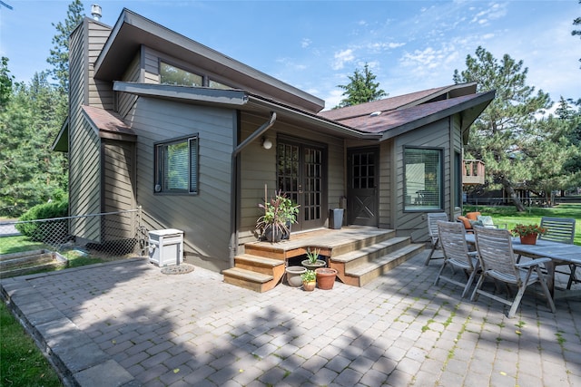 4280 Fox Farm Rd, Missoula, MT 59802 - back of house featuring a patio, a chimney, and outdoor dining area