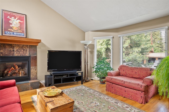 4280 Fox Farm Rd, Missoula, MT 59802 - living area featuring lofted ceiling, wood finished floors, and a tiled fireplace