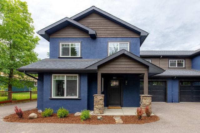 441 Karrow Ave, Whitefish, MT 59937 - view of front of property with stucco siding, driveway, and a shingled roof