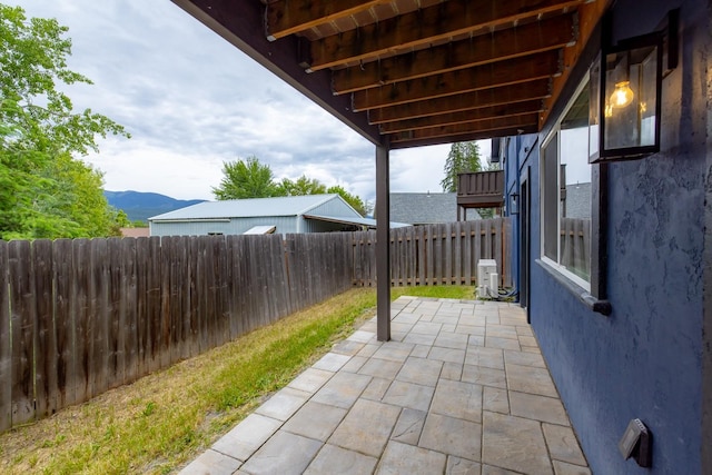 441 Karrow Ave, Whitefish, MT 59937 - fenced backyard with a patio area and a mountain view