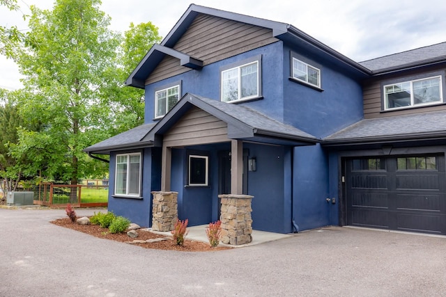 441 Karrow Ave, Whitefish, MT 59937 - craftsman house featuring a garage, stucco siding, and a shingled roof