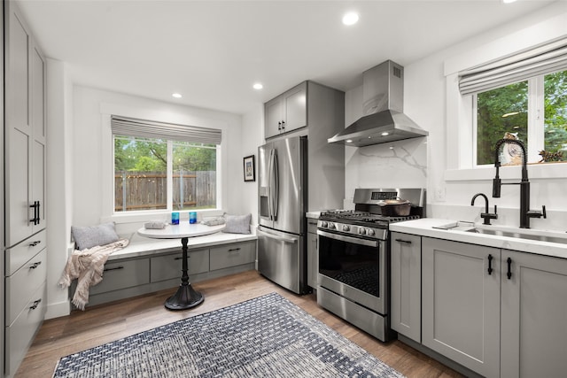 441 Karrow Ave, Whitefish, MT 59937 - kitchen featuring wall chimney exhaust hood, appliances with stainless steel finishes, gray cabinetry, plenty of natural light, and recessed lighting