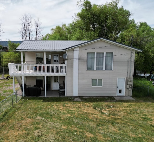 3265 US Highway 2 W, Kalispell, MT 59901 - back of house with a fenced backyard, a patio, and a metal roof