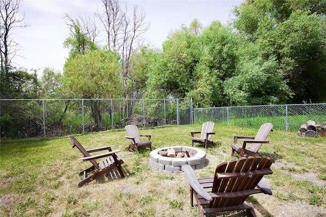 3265 US Highway 2 W, Kalispell, MT 59901 - fenced backyard featuring an outdoor fire pit