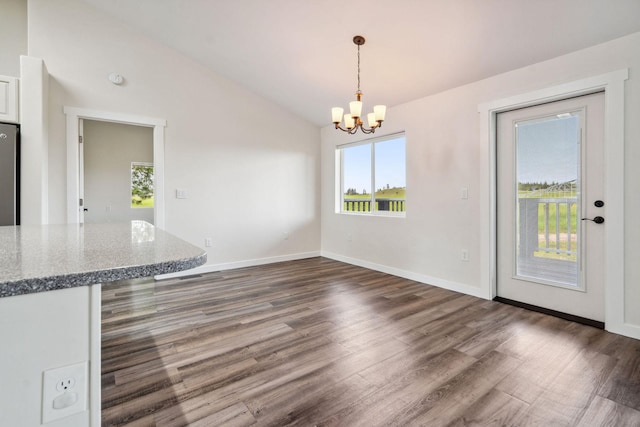 378 Last Best Pl, Kalispell, MT 59901 - unfurnished dining area featuring vaulted ceiling, a chandelier, and dark wood-type flooring