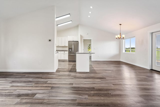 378 Last Best Pl, Kalispell, MT 59901 - unfurnished living room featuring a chandelier, dark wood-style floors, and high vaulted ceiling