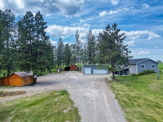 378 Last Best Pl, Kalispell, MT 59901 - view of front of property featuring a garage, a front yard, driveway, and an outdoor structure