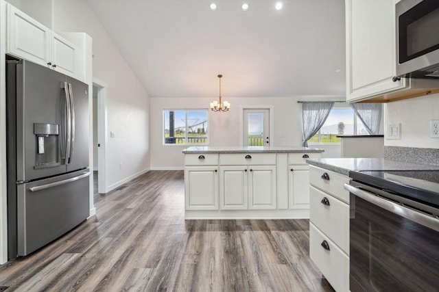 378 Last Best Pl, Kalispell, MT 59901 - kitchen featuring stainless steel appliances, a chandelier, healthy amount of natural light, white cabinets, and lofted ceiling