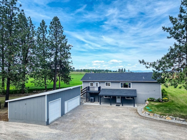 378 Last Best Pl, Kalispell, MT 59901 - view of front of home featuring a garage, a deck, and an outbuilding