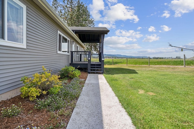 378 Last Best Pl, Kalispell, MT 59901 - view of grassy yard with a deck with mountain view and a view of rural / pastoral area