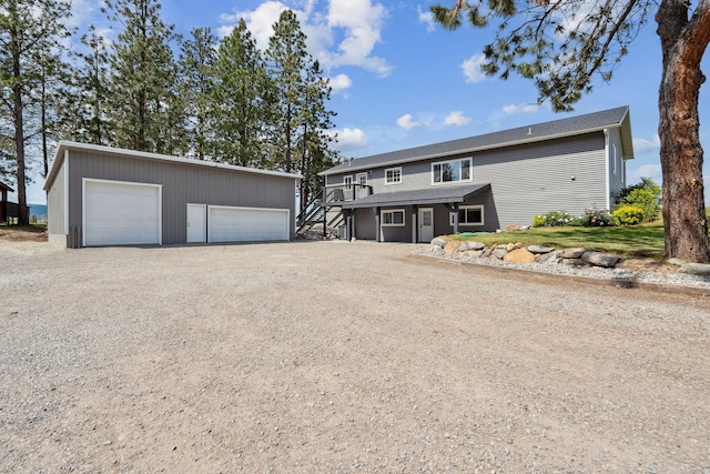 378 Last Best Pl, Kalispell, MT 59901 - view of front of house featuring stairway, an outdoor structure, a garage, and a wooden deck
