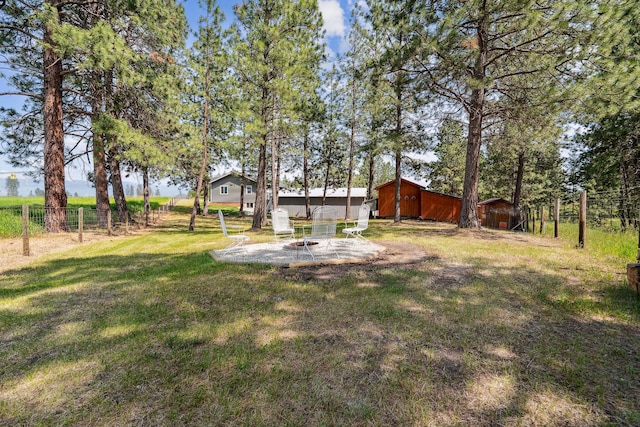 378 Last Best Pl, Kalispell, MT 59901 - view of yard with an outdoor fire pit, an outbuilding, and a patio area