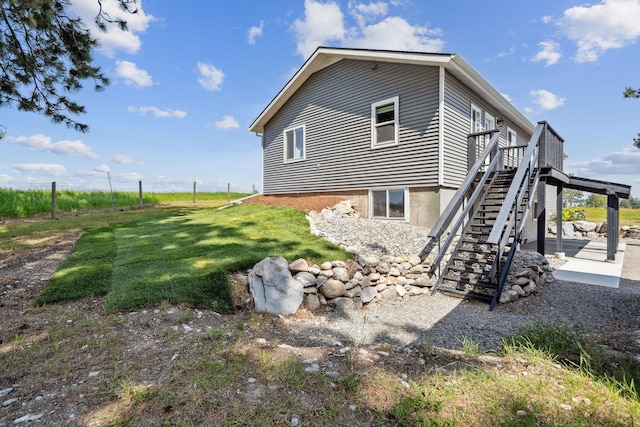 378 Last Best Pl, Kalispell, MT 59901 - view of home's exterior with stairway, a lawn, and a wooden deck
