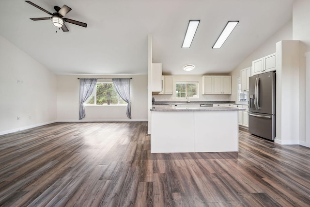 378 Last Best Pl, Kalispell, MT 59901 - kitchen featuring stainless steel fridge, vaulted ceiling, open floor plan, white cabinetry, and dark wood-style flooring