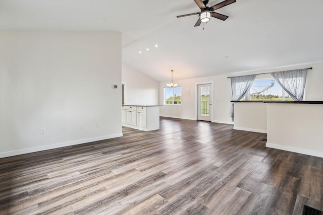 378 Last Best Pl, Kalispell, MT 59901 - unfurnished living room with a chandelier, ceiling fan, dark wood-style floors, and high vaulted ceiling