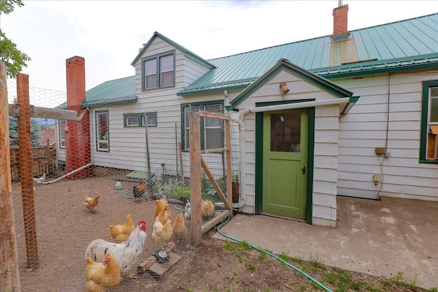 407 1st Ave W, Eureka, MT 59917 - view of front of home with a metal roof, a chimney, and a standing seam roof