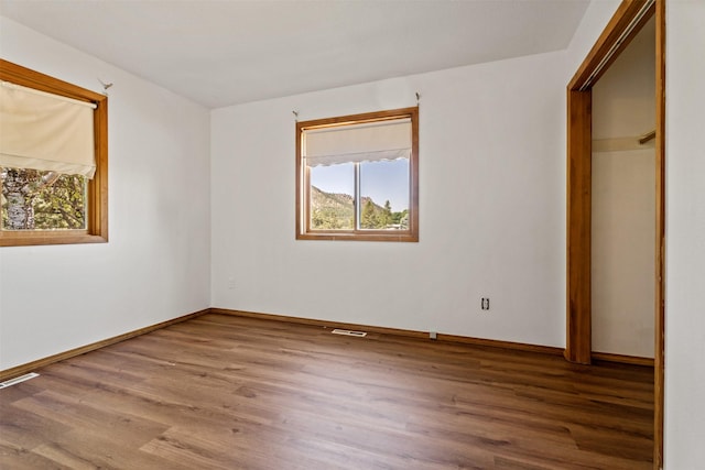 14470 Harpers Bridge Rd, Missoula, MT 59808 - unfurnished bedroom with multiple windows and wood finished floors