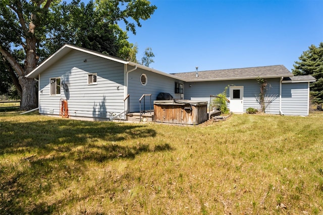 14470 Harpers Bridge Rd, Missoula, MT 59808 - back of property featuring a hot tub and a lawn