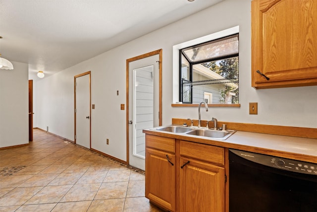 14470 Harpers Bridge Rd, Missoula, MT 59808 - kitchen with black dishwasher, light countertops, light tile patterned flooring, and brown cabinetry