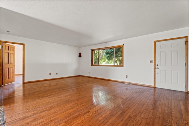 14470 Harpers Bridge Rd, Missoula, MT 59808 - unfurnished room with wood-type flooring and a textured ceiling