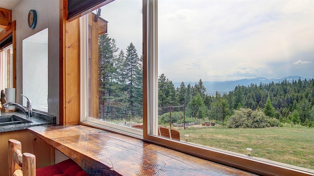 18998 Oris Ln, Florence, MT 59833 - sunroom featuring a view of trees, plenty of natural light, and a mountain view