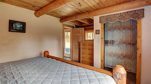 18998 Oris Ln, Florence, MT 59833 - bedroom with a wooden ceiling with exposed beams and light carpet