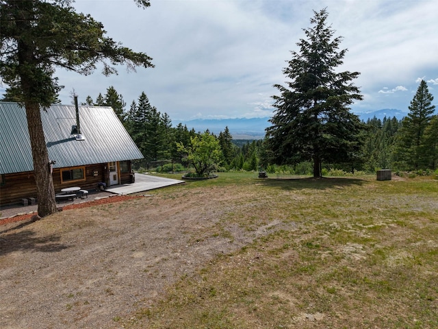 18998 Oris Ln, Florence, MT 59833 - view of green lawn with a patio area and a view of trees