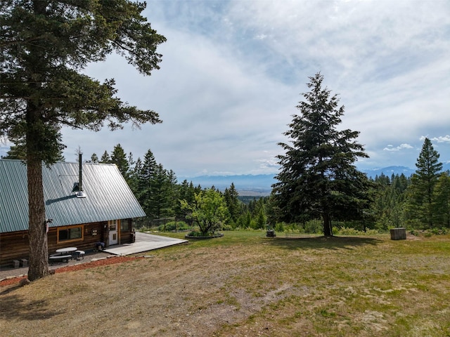 18998 Oris Ln, Florence, MT 59833 - view of green lawn with a patio area and a forest view