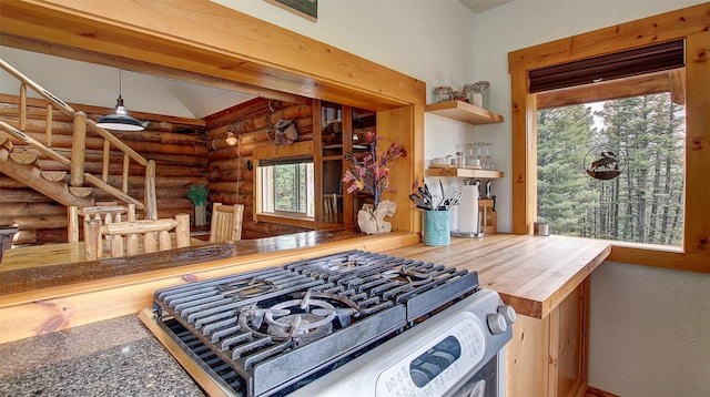 18998 Oris Ln, Florence, MT 59833 - kitchen with log walls, gas stove, vaulted ceiling, open shelves, and decorative light fixtures