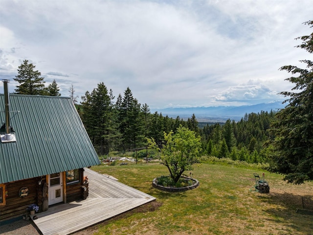 18998 Oris Ln, Florence, MT 59833 - view of grassy yard with a wooden deck and a forest view