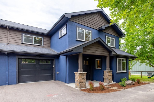 443 Karrow Ave, Whitefish, MT 59937 - craftsman-style house with a garage, stucco siding, asphalt driveway, and a porch