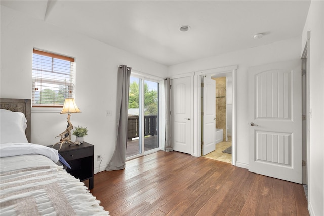 443 Karrow Ave, Whitefish, MT 59937 - bedroom featuring access to outside, wood finished floors, and connected bathroom