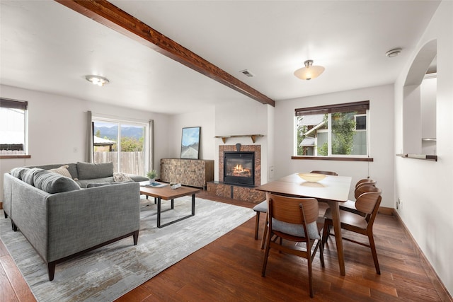 443 Karrow Ave, Whitefish, MT 59937 - dining space featuring wood finished floors, a tile fireplace, beamed ceiling, and arched walkways