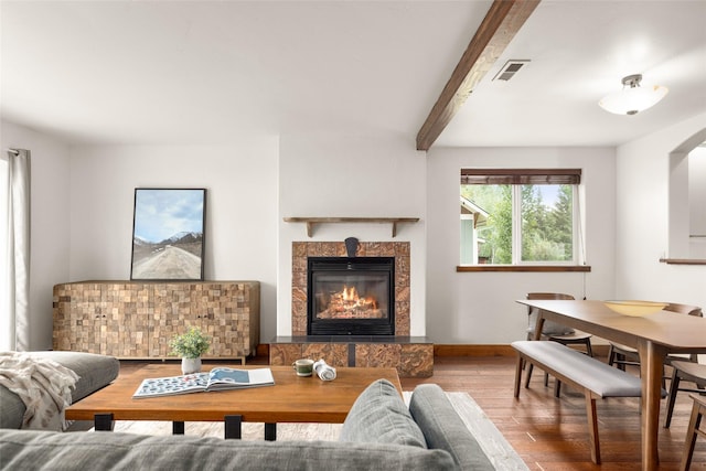 443 Karrow Ave, Whitefish, MT 59937 - living area featuring wood finished floors, a tiled fireplace, and beam ceiling