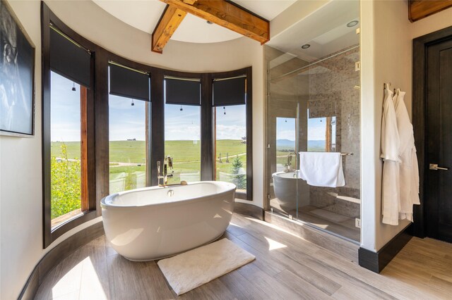 155 Peacemaker Rdg, Belt, MT 59412 - bathroom featuring a shower stall, beamed ceiling, wood finished floors, and a soaking tub