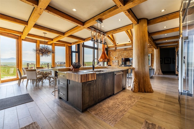 155 Peacemaker Rdg, Belt, MT 59412 - kitchen with a chandelier, stainless steel dishwasher, a center island with sink, dark brown cabinets, and coffered ceiling