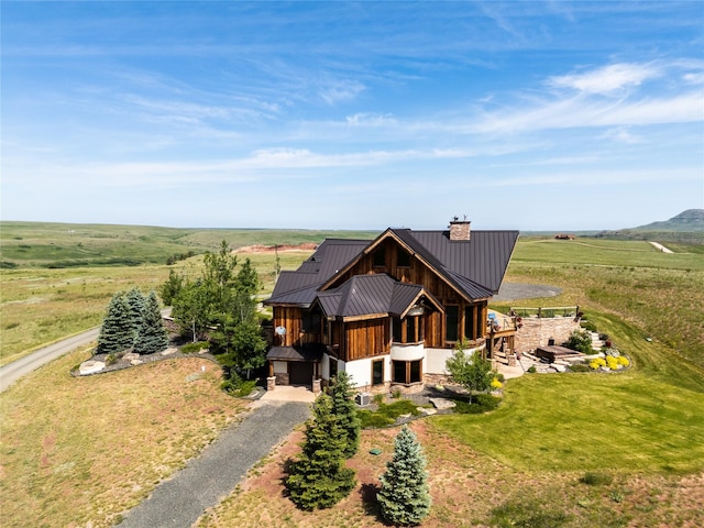 155 Peacemaker Rdg, Belt, MT 59412 - view of front of property with a chimney, a standing seam roof, a metal roof, driveway, and a view of rural / pastoral area