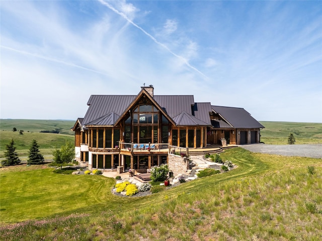 155 Peacemaker Rdg, Belt, MT 59412 - rear view of house featuring asphalt driveway, a chimney, a standing seam roof, and a metal roof