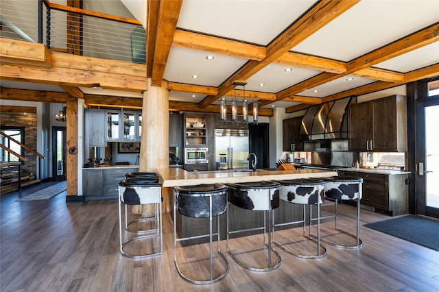 155 Peacemaker Rdg, Belt, MT 59412 - kitchen featuring custom range hood, light countertops, dark wood-style flooring, beamed ceiling, and coffered ceiling