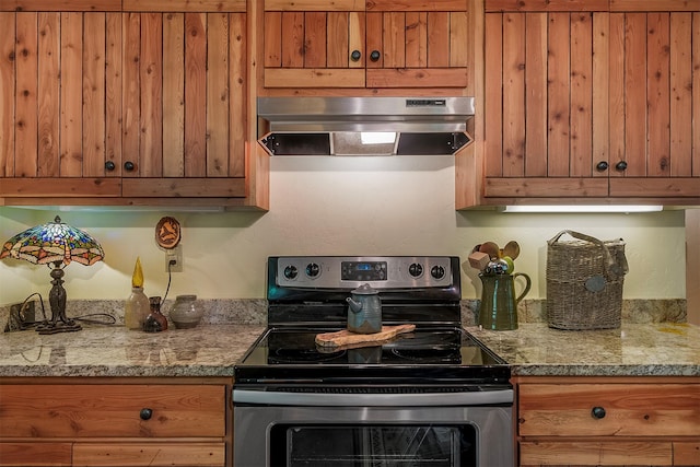 983 Lake Dr, Columbia Falls, MT 59912 - kitchen featuring stainless steel range with electric stovetop, wall chimney range hood, and brown cabinetry