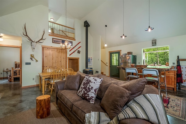 983 Lake Dr, Columbia Falls, MT 59912 - living area featuring high vaulted ceiling, a chandelier, and finished concrete floors