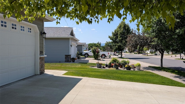 209 E Nicklaus Ave, Kalispell, MT 59901 - view of grassy yard with a garage and driveway