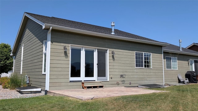 209 E Nicklaus Ave, Kalispell, MT 59901 - rear view of house with a patio and a lawn