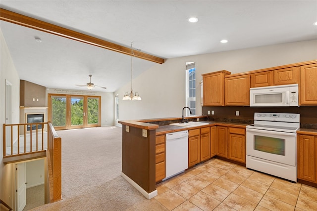 209 E Nicklaus Ave, Kalispell, MT 59901 - kitchen with white appliances, open floor plan, a peninsula, a chandelier, and dark countertops