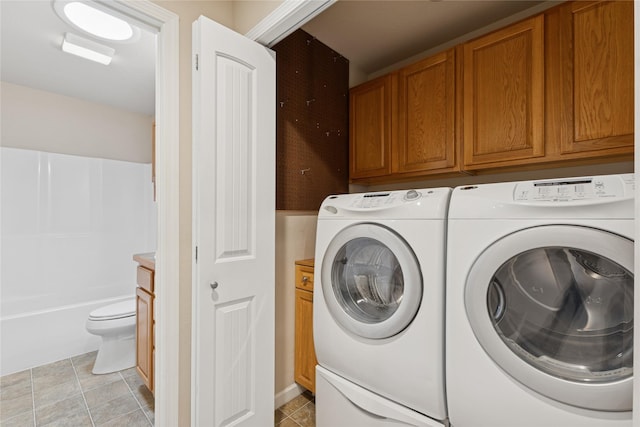 209 E Nicklaus Ave, Kalispell, MT 59901 - laundry room featuring washing machine and clothes dryer, light tile patterned floors, and cabinet space